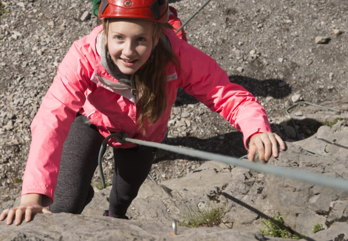 girl climbing using a rope