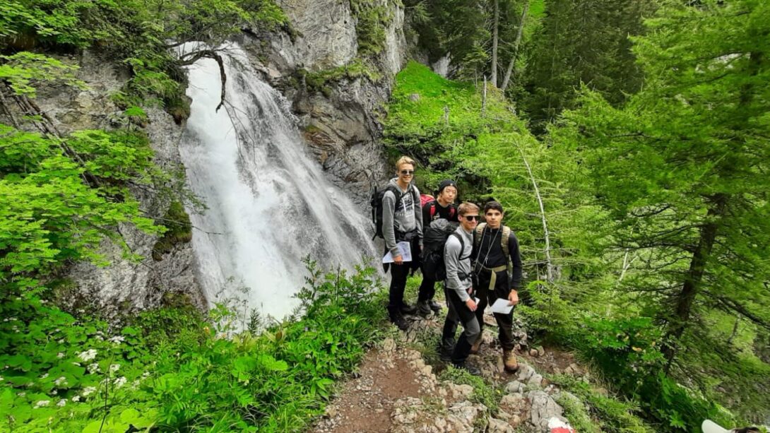 Students in front of a waterfall